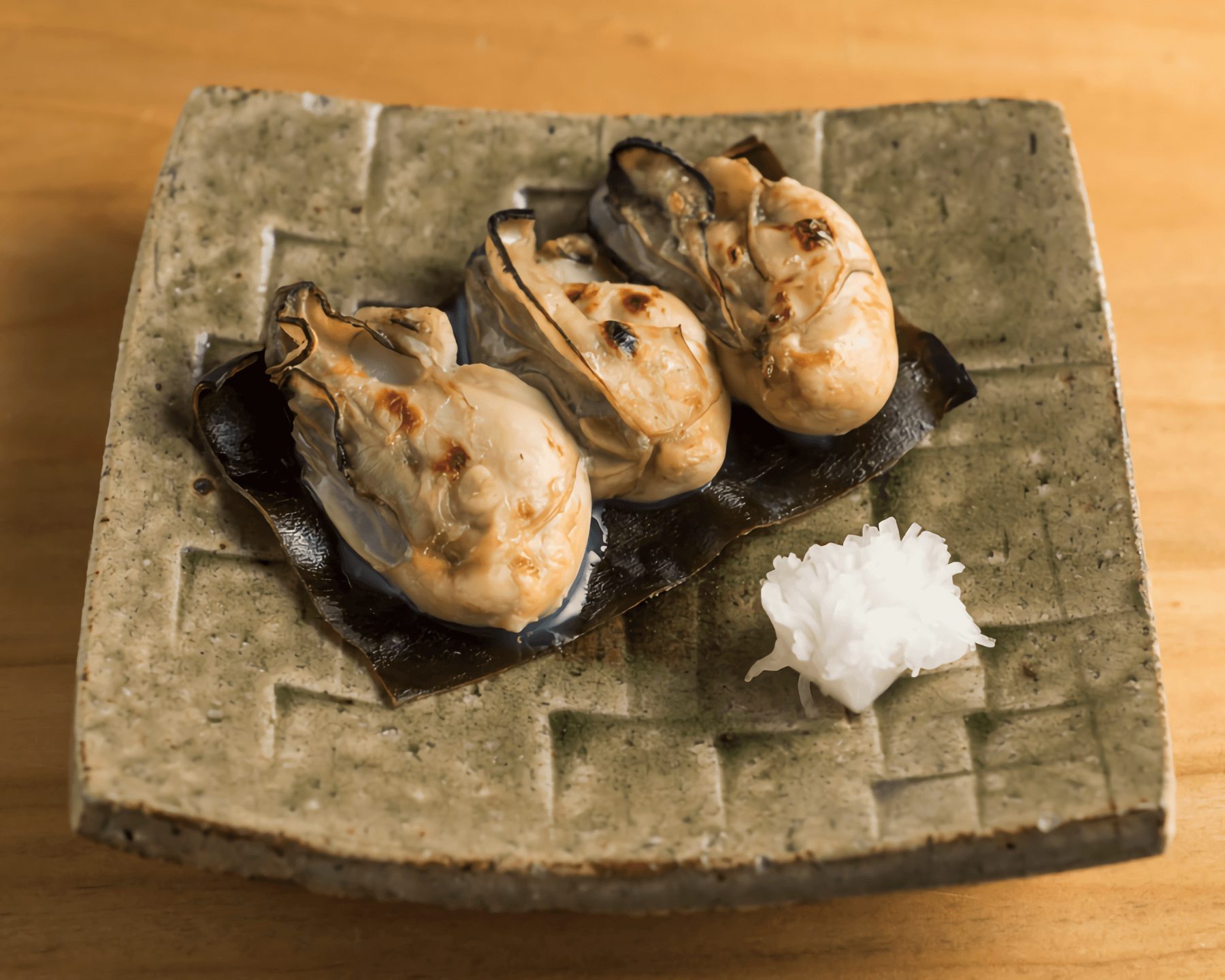 Grilled oyster with kelp